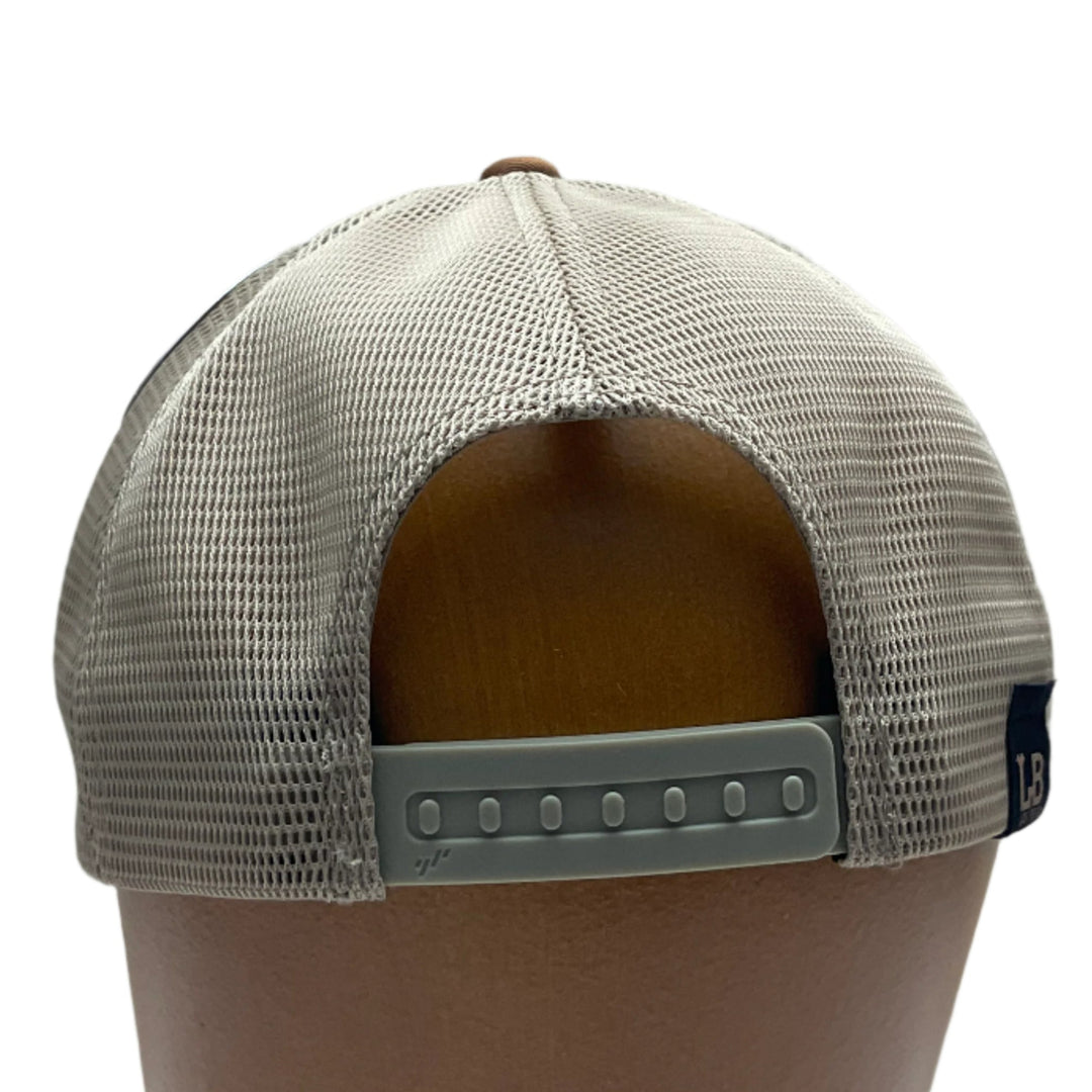 Back of an Elk Hand Dyed Leather Patch Flexfit Hat, featuring a hexagonal hand-dyed leather patch etched with the silhouette of an elk and the letters “MT”, securely sewn to the structured front of a camel and cream colored Flexfit trucker hat—handmade in Montana, USA by Last Best Supply Co.