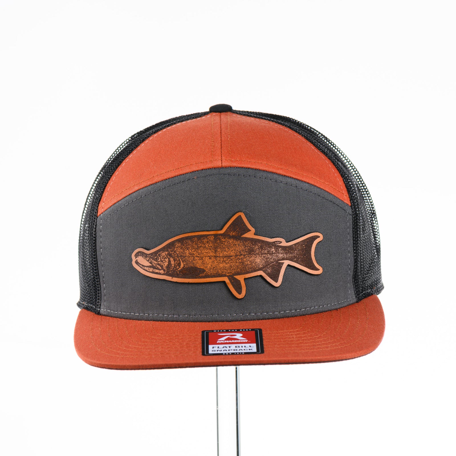 Etched Leather Chinook Salmon Patch Flat Bill Trucker Hat, featuring a real leather patch cut into the shape of a Chinook Salmon and etched with detail, securely attached to an orange and grey trucker hat—handmade in Montana, USA by Last Best Supply Co.