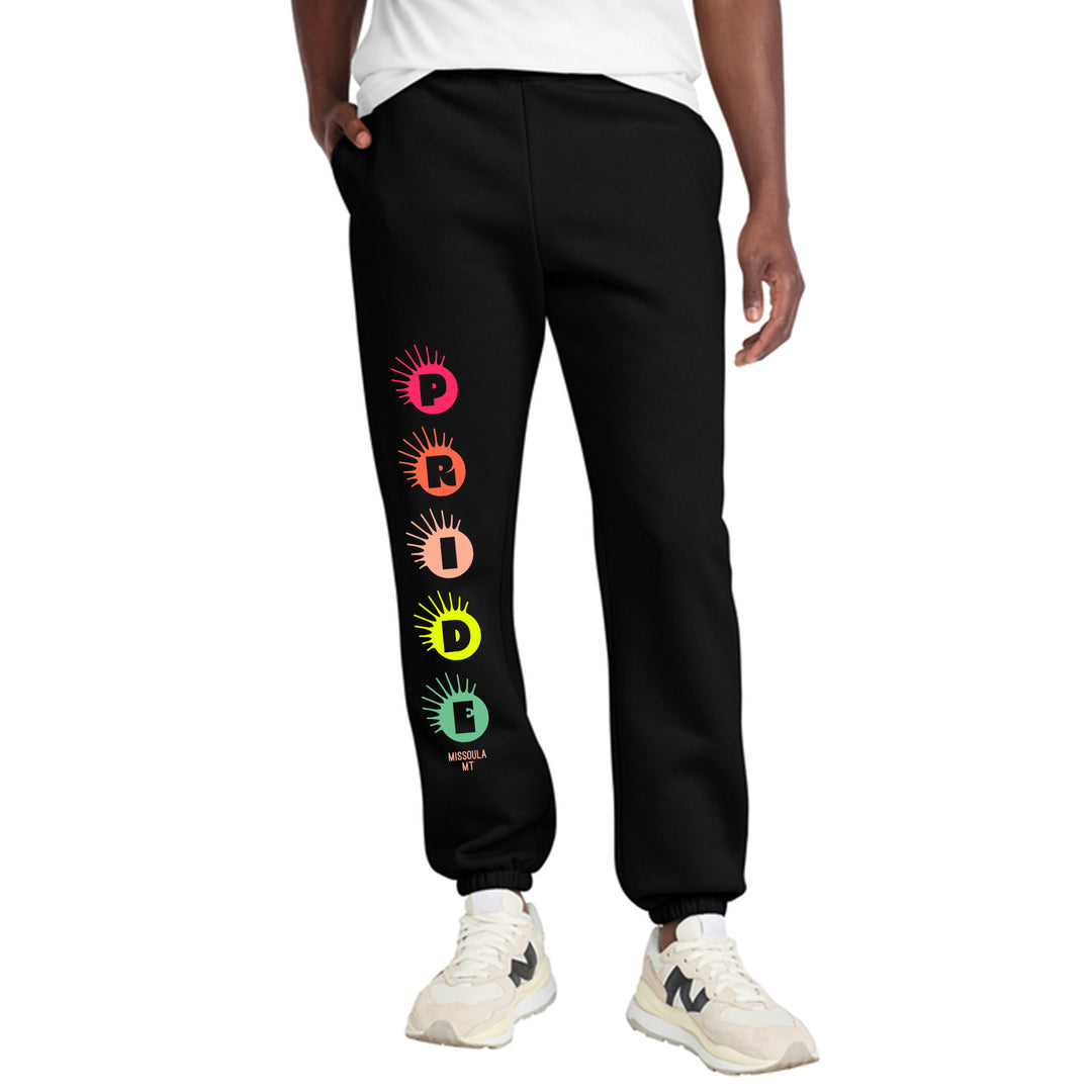 Black sweatpants with 2026 Missoula Pride design worn by a person on a white background