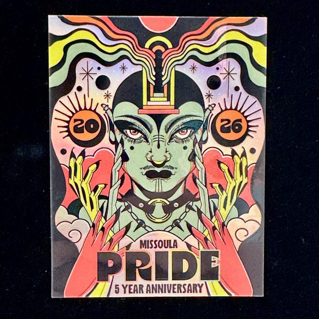A close up of the Missoula Pride 5 Year anniversary metallic sticker on a black background