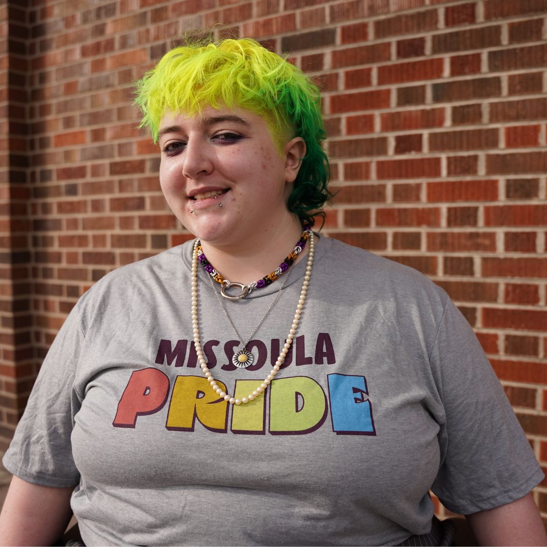 Grey all-gender / unisex t-shirt featuring the Missoula PRIDE logo made in Montana, USA; a portion of sales are donated to the Missoula Pride fundraiser.