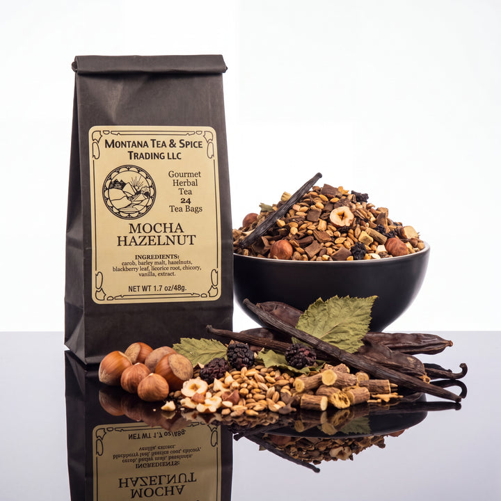 A bag of Montana Tea &amp; Spice Trading LLC Mocha Hazelnut herbal tea stands on a reflective black surface next to a bowl filled with the tea blend and loose ingredients including hazelnuts, cinnamon sticks, vanilla beans, and dried berries.