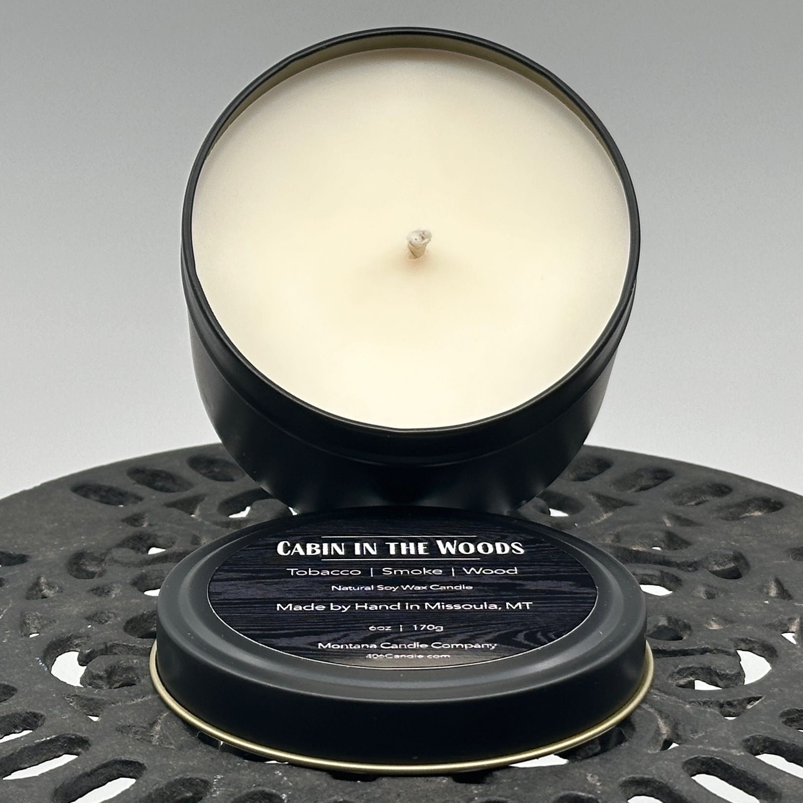 Cabin in the Woods Candle handmade in Missoula, Montana by Montana Candle Company, with a blend of tobacco, smoke, and wood scents, in a 6 oz. tin