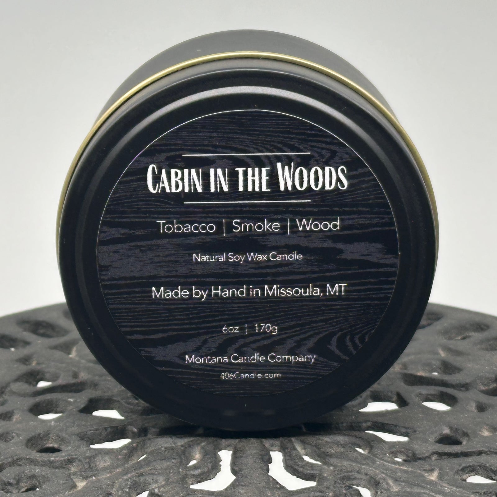 Cabin in the Woods Candle handmade in Missoula, Montana by Montana Candle Company, with a blend of tobacco, smoke, and wood scents, in a 6 oz. tin