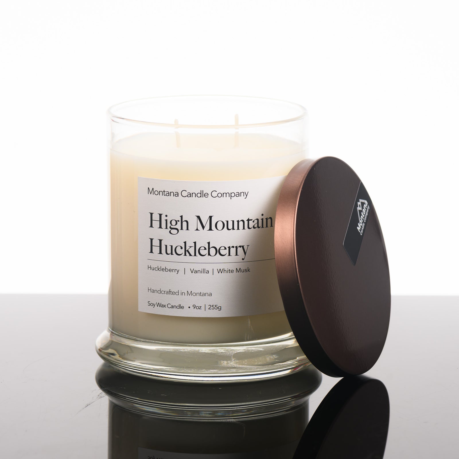 High Mountain Huckleberry Candle soy blend candle handmade in Missoula, Montana by Montana Candle Company, with a blend of Huckleberry, Vanilla, and White Musk, 9 oz. glass tumbler