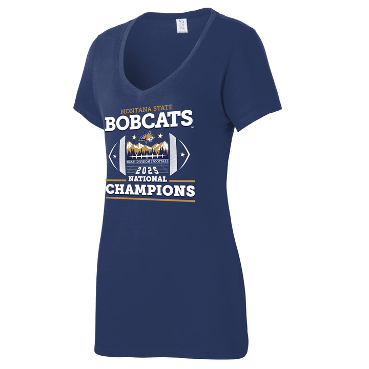 This is a Navy Blue short-sleeved V-neck t-shirt with a tapered, feminine fit. The fabric is thin, soft, and smooth to the touch. On the front, there is a large, multi-layered screen-printed graphic. You can feel the distinct edges of the block lettering for "Bobcats" and "Champions," along with the slightly raised texture of the central football-shaped emblem that contains sharp mountain peaks.