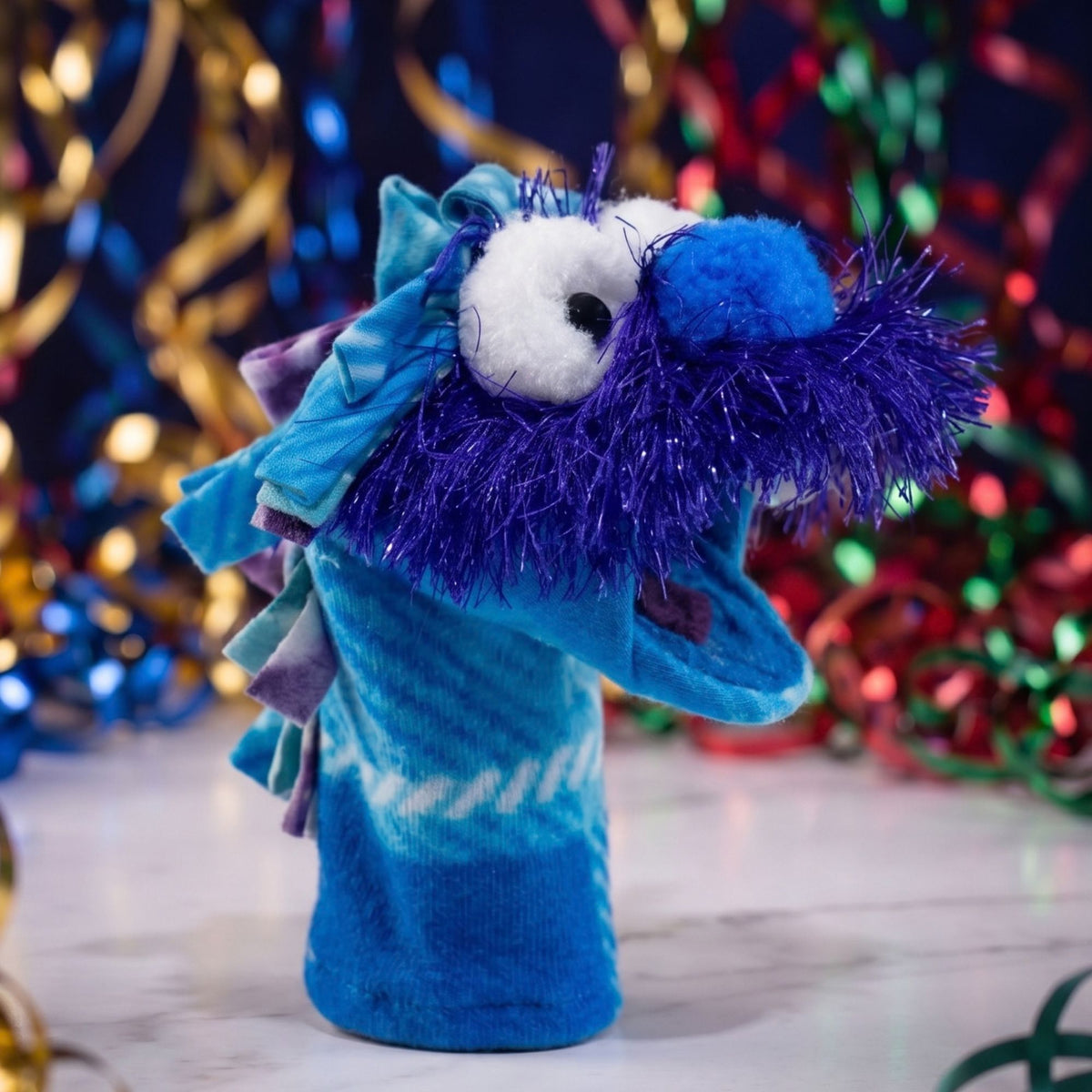 Bring play to life with Chickies, a handcrafted blue puppet from Montana featuring a quirky purple mustache. Perfect for imaginative fun and gifts!