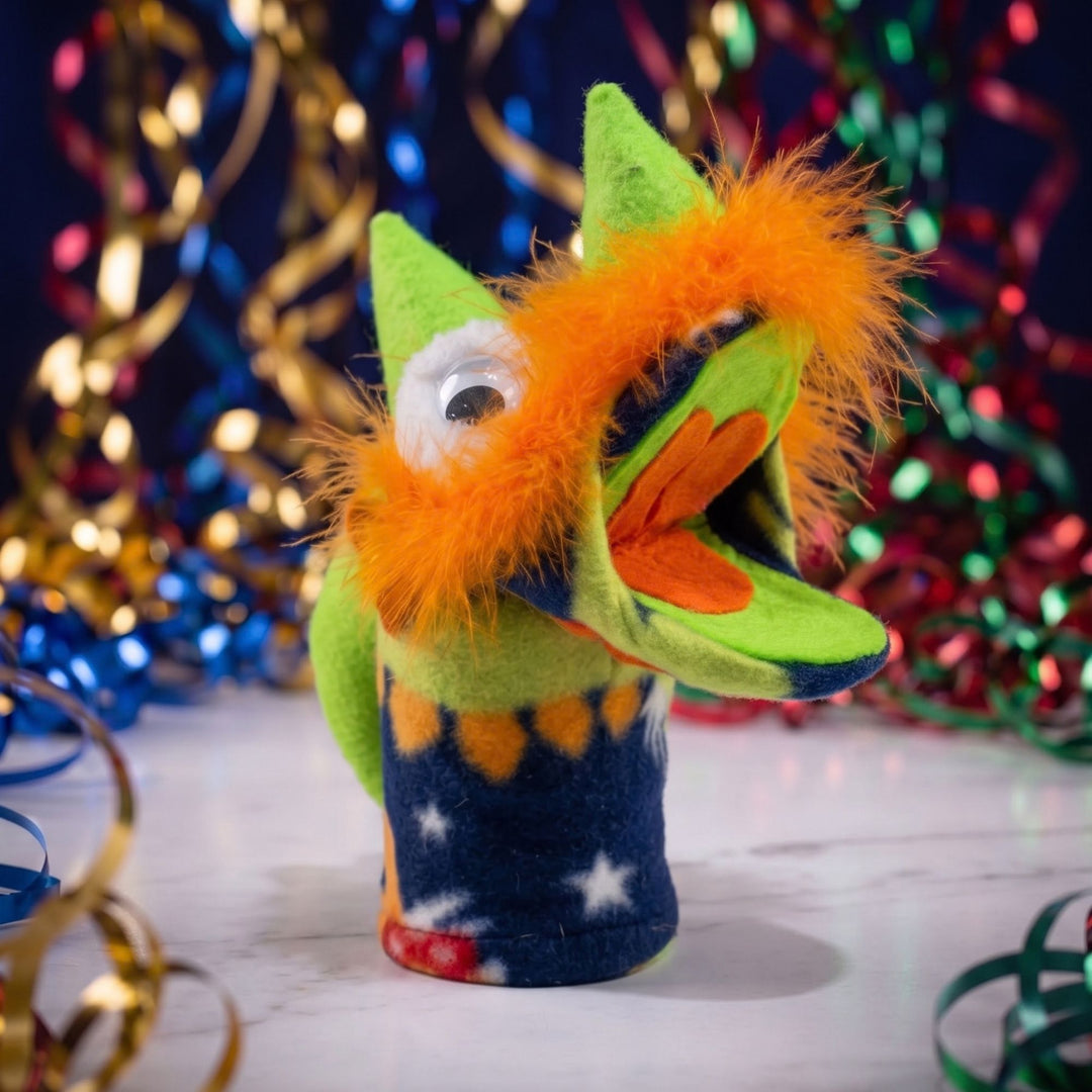 Spark imaginative play with Rocky Mountain Dino, a handcrafted Montana puppet featuring bright green fleece, starry pattern, and orange trim.