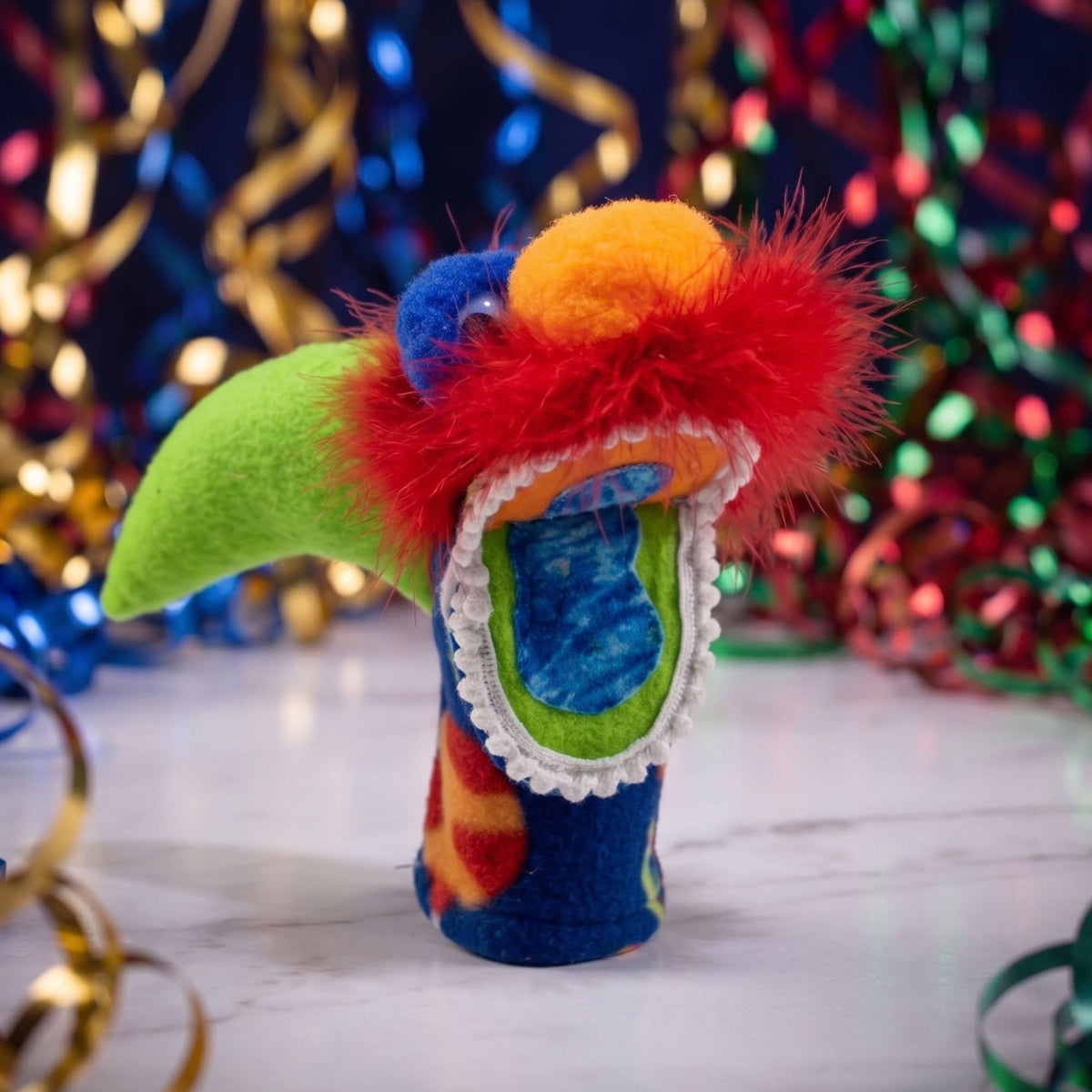 Handcrafted in Montana, the Montana Timber Shark hand puppet features colorful fleece, soft feathers, & lace trim. Perfect for creative play & unique gifts!