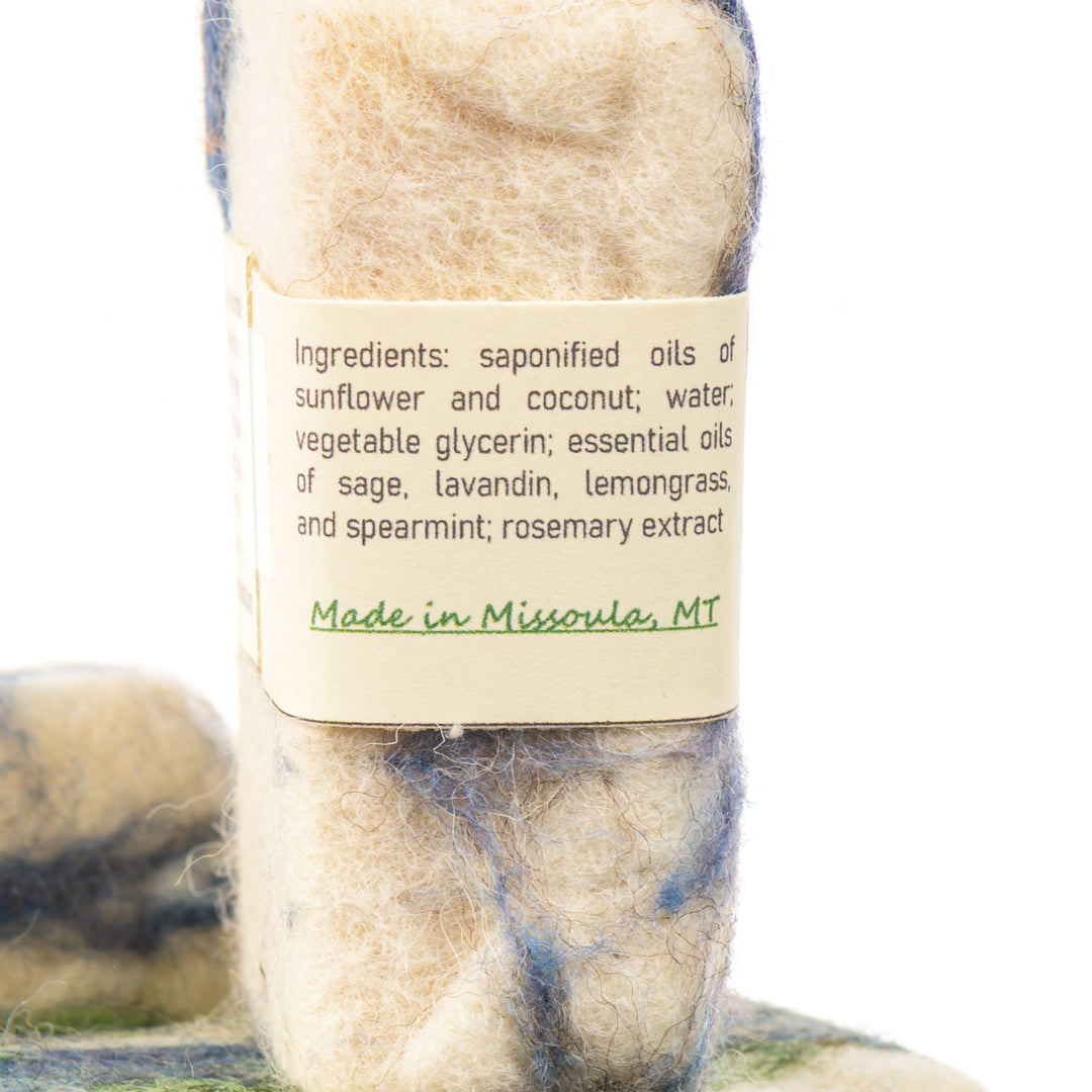 Bar of soap with a label detailing ingredients and origin, on a white background Made in Missoula Montana