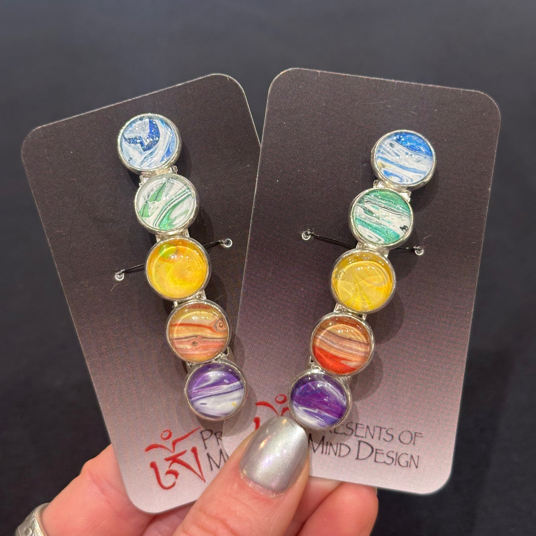Two barrettes made with hand poured acrylic in a rainbow color palette made in Montana 