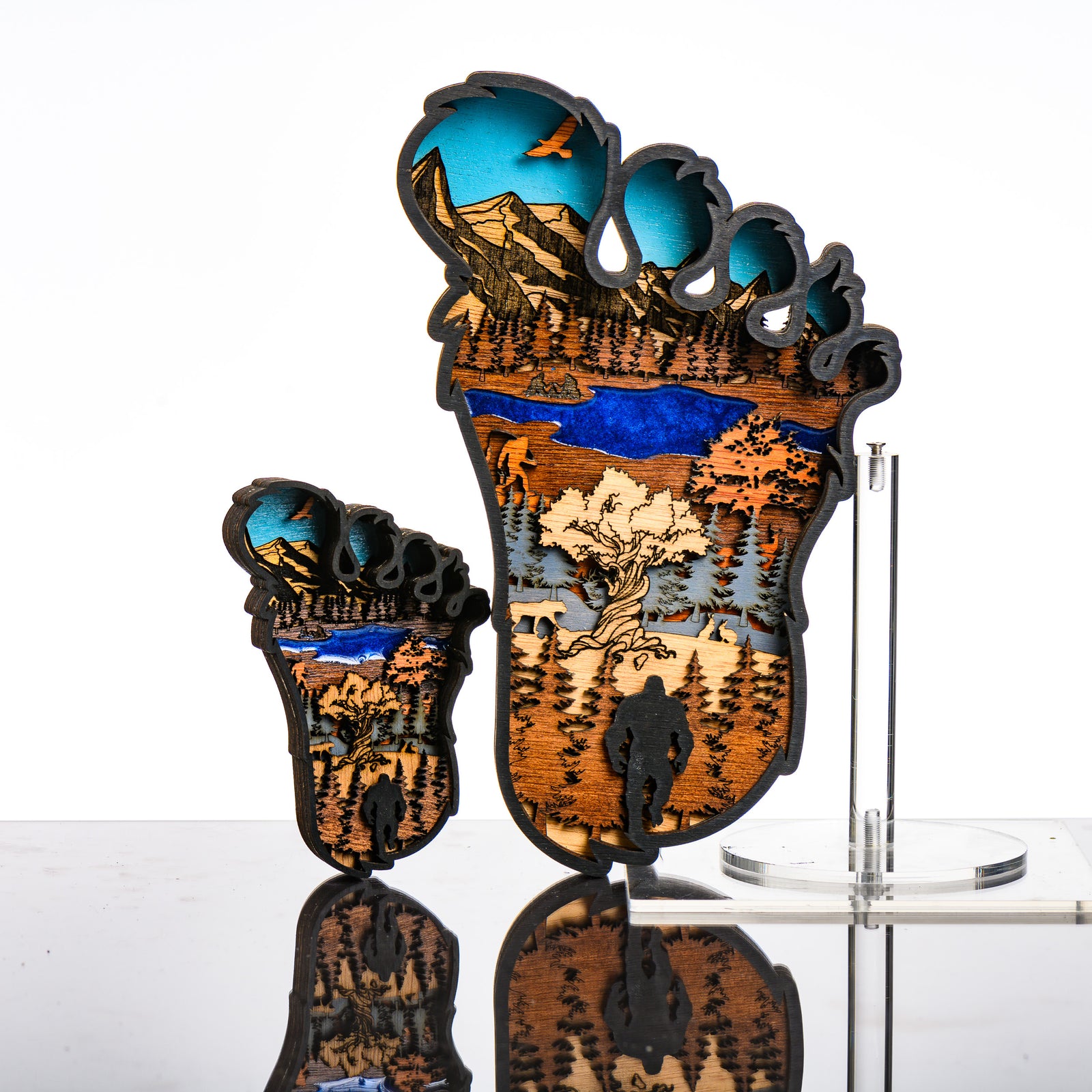 Bigfoot 3D Layered Wood Artmade in Montana by RJS Engraving & Design - laser-cut wood art depicting a wilderness scene inside the silhouette of a Bigfoot foot, multiple sizes