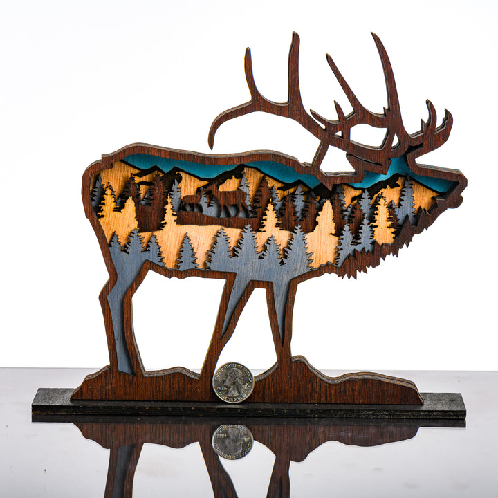 Elk 3D Layered Wood Art made in Montana by RJS Engraving & Design - laser-cut wood art depicting trees and mountains inside the silhouette of an elk, Standard with scale