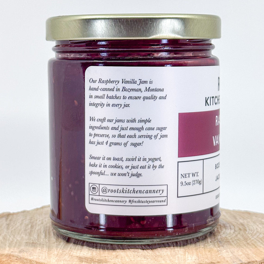 The side of the jar of raspberry vanilla jam, reading hand-canned in bozeman, montana in small batches to ensure quality and integrity in every jar.