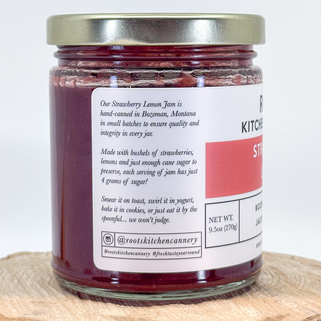 The side of a jar of strawberry lemon jam that reads Our strawberry lemon jam is hand-canned in Bozeman, Montana in small batches to ensure quality and integrity in every jar.