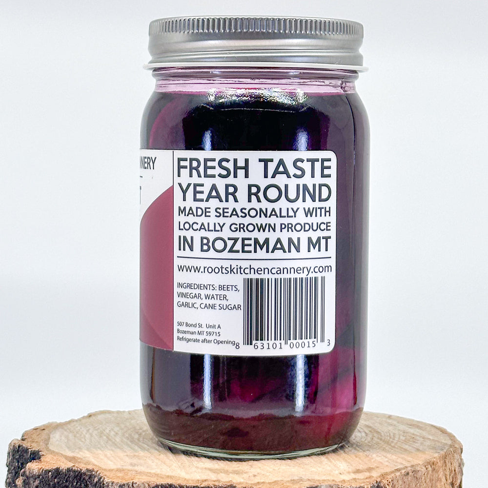 The side of a jar of beet and garlic pickles that reads Fresh taste year round, made seasonally with locally grown produce in Bozeman, MT. The ingredients are beets, vinegar, water, garlic, cane sugar
