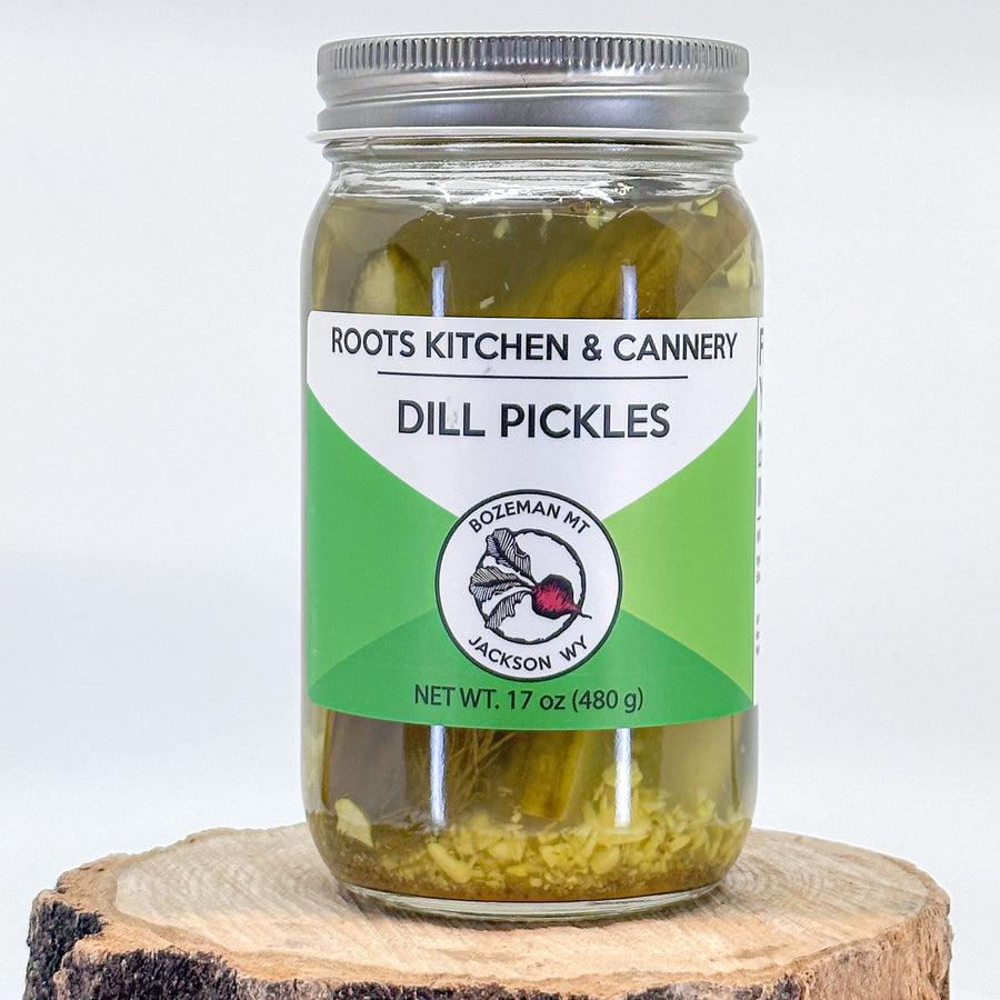 A picture of a 17oz jar of Dill pickles made by Roots kitchen and Cannery