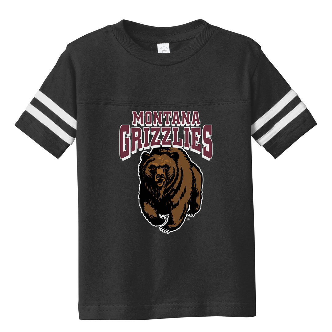 A black toddler T-shirt with white stripes on the sleeve. Printed with the University of Montana Grizzlies' charging bear logo.