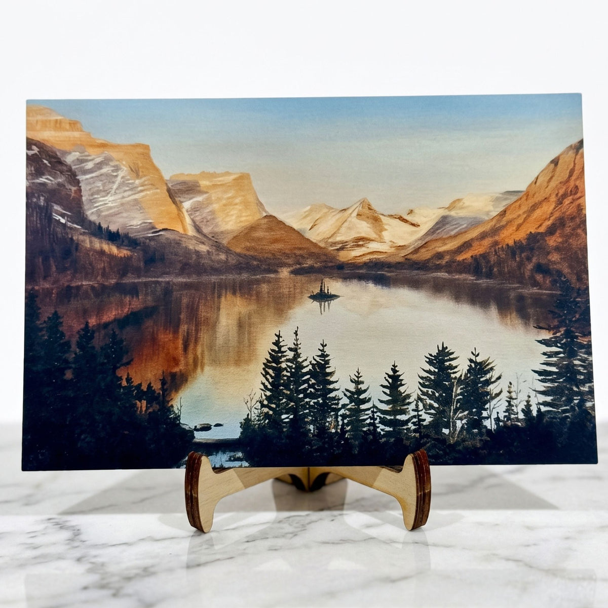Capture Glacier National Park's beauty with the Rising Sun Postcard by Stark Mountain Studio, featuring Bobbe Almer’s watercolor art of St. Mary Lake.