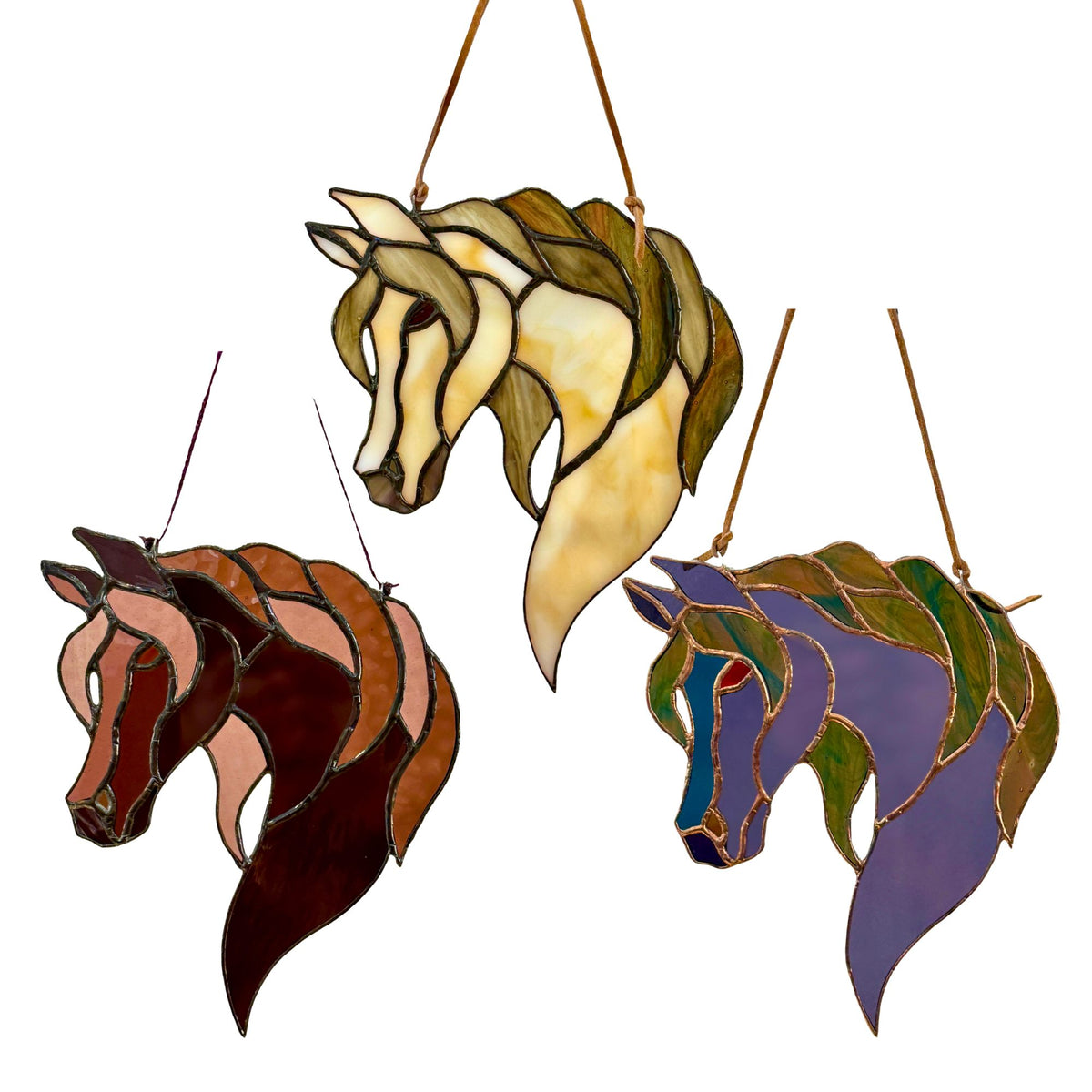 Three stained glass horse head hanging stained glass ornaments in different colors, shown against a plain white background.