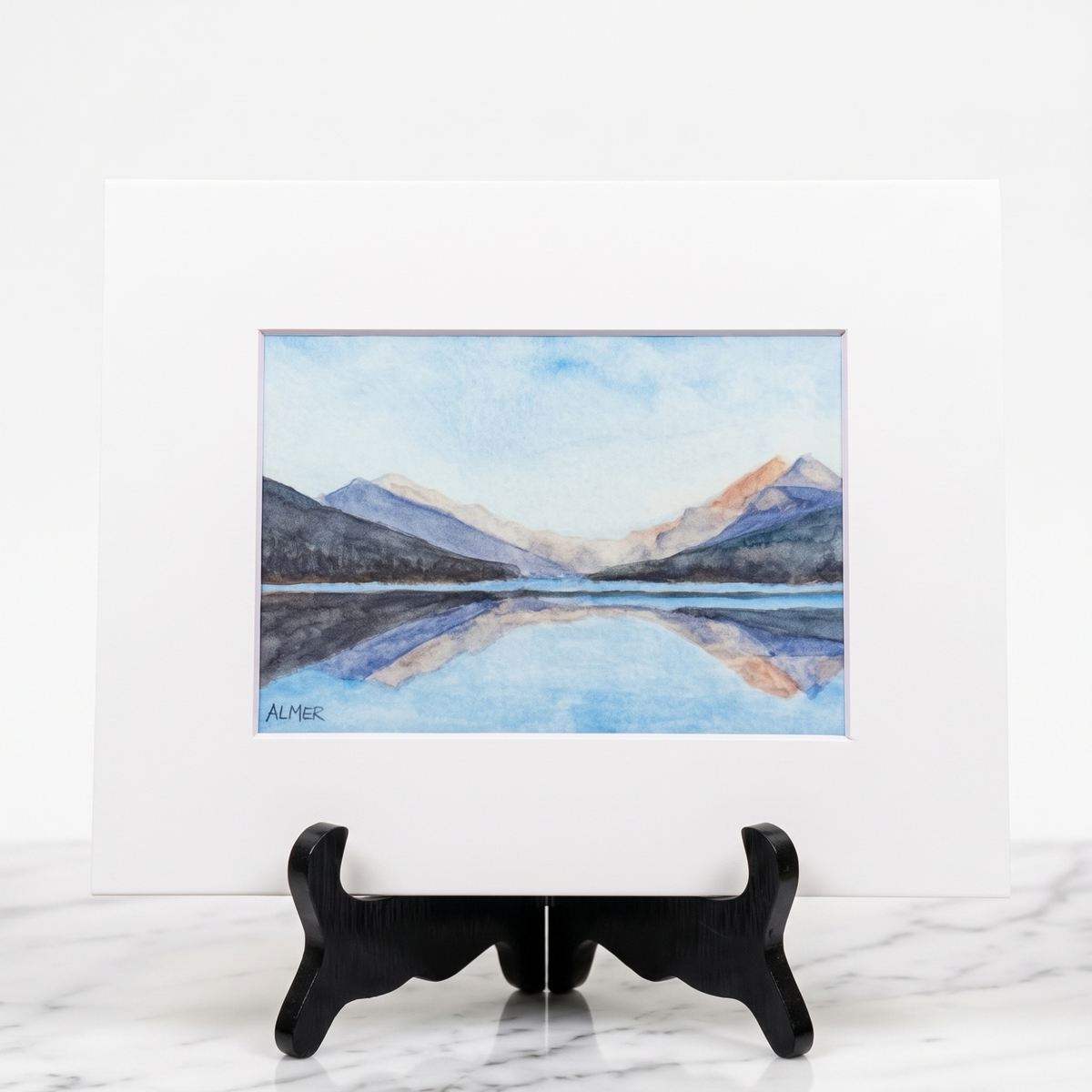 Bring Montana's wilderness home with the Bowman Lake II Matted Print by Stark Mountain Studio, featuring a Bobbe Almer Glacier National Park watercolor.   