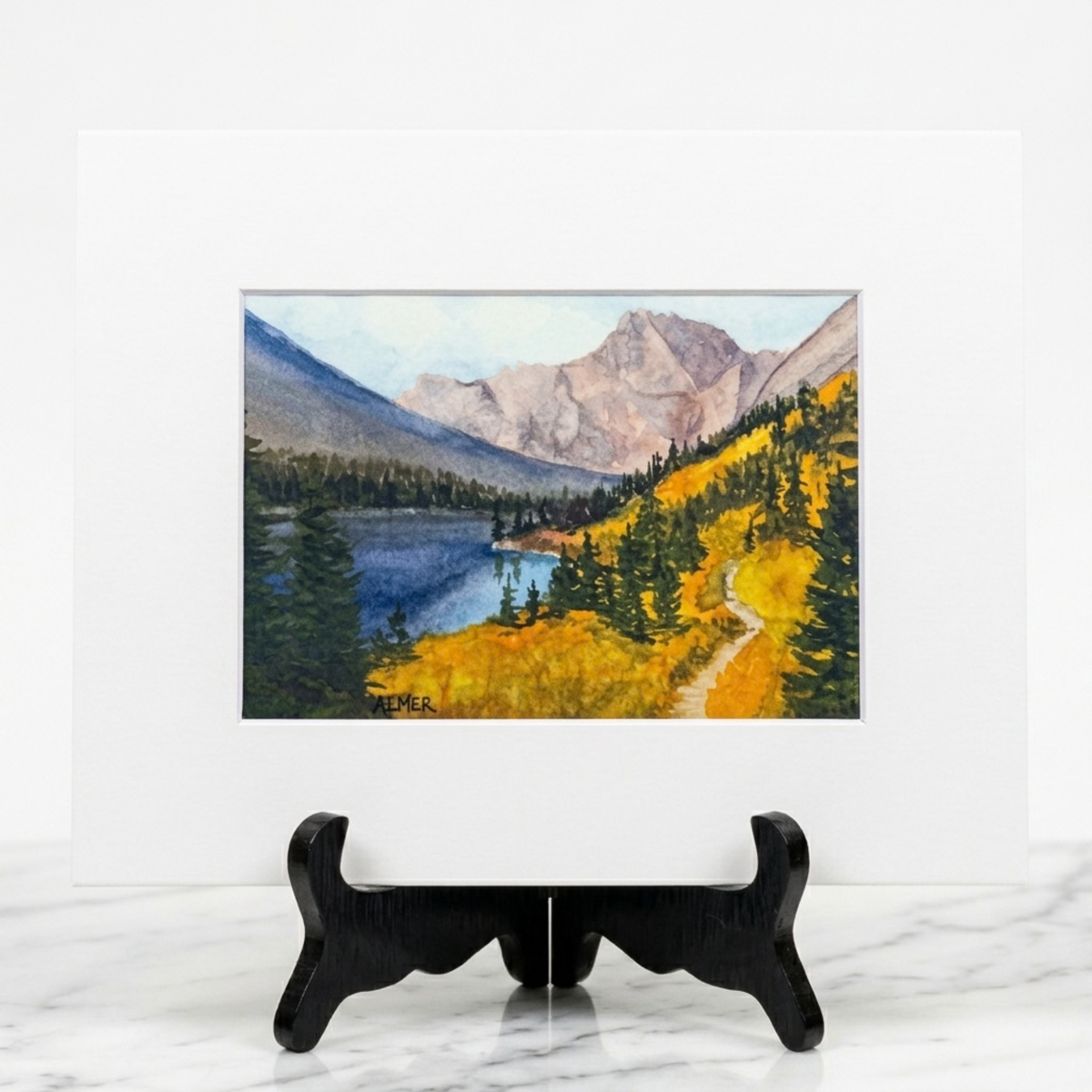 Celebrate Glacier National Park's autumn beauty with the Glacier Gold Matted Print by Stark Mountain Studio featuring watercolor art by Bobbe Almer.