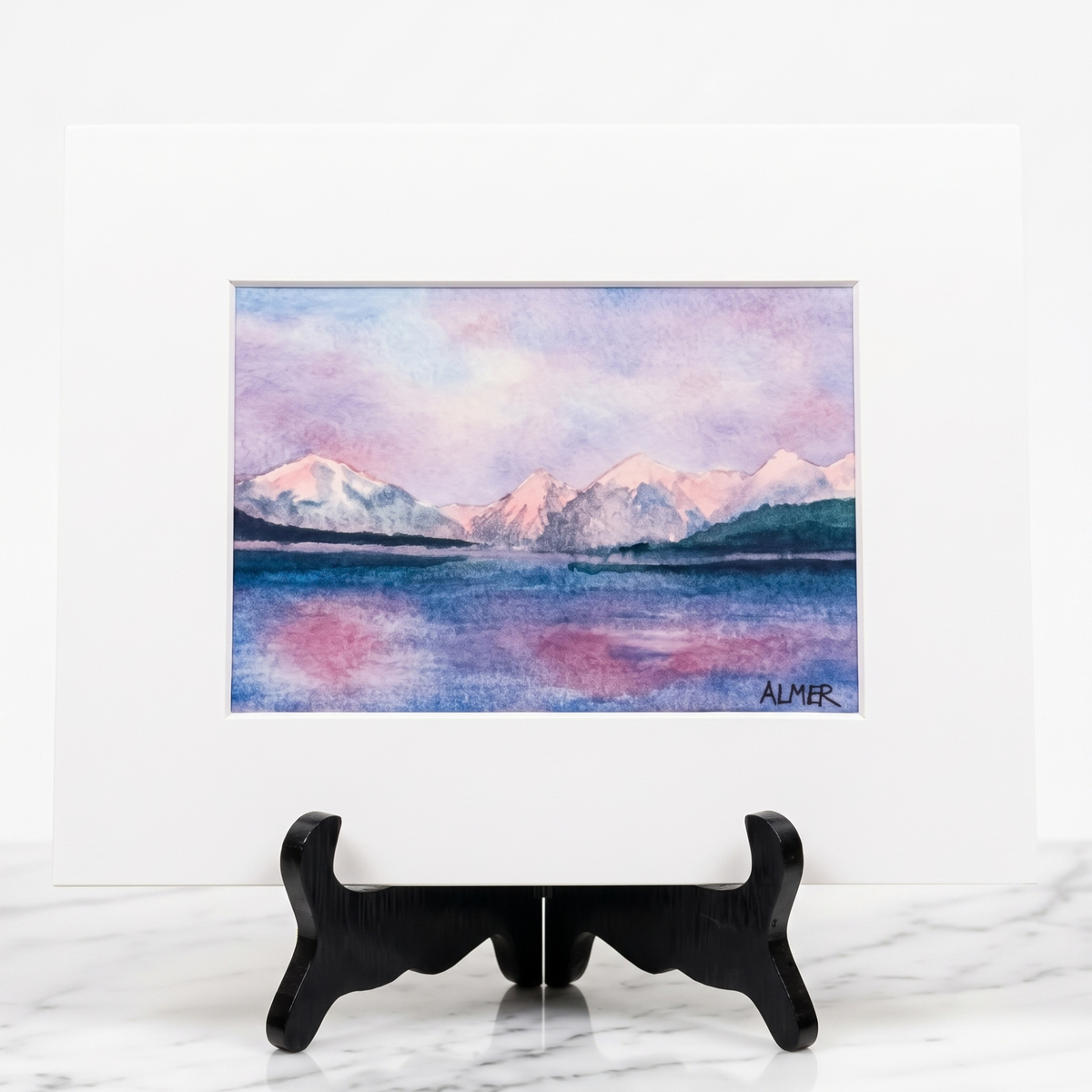 Bring Glacier National Park home with the Lake McDonald Sunset Matted Print by Stark Mountain Studio. A colorful Bobbe Almer watercolor reproduction.