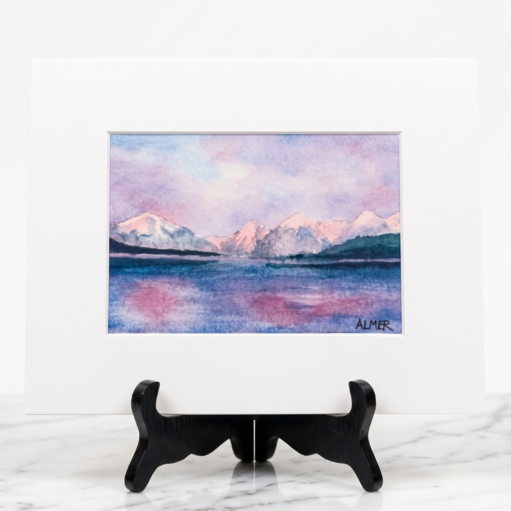 Bring Glacier National Park home with the Lake McDonald Sunset Matted Print by Stark Mountain Studio. A colorful Bobbe Almer watercolor reproduction.