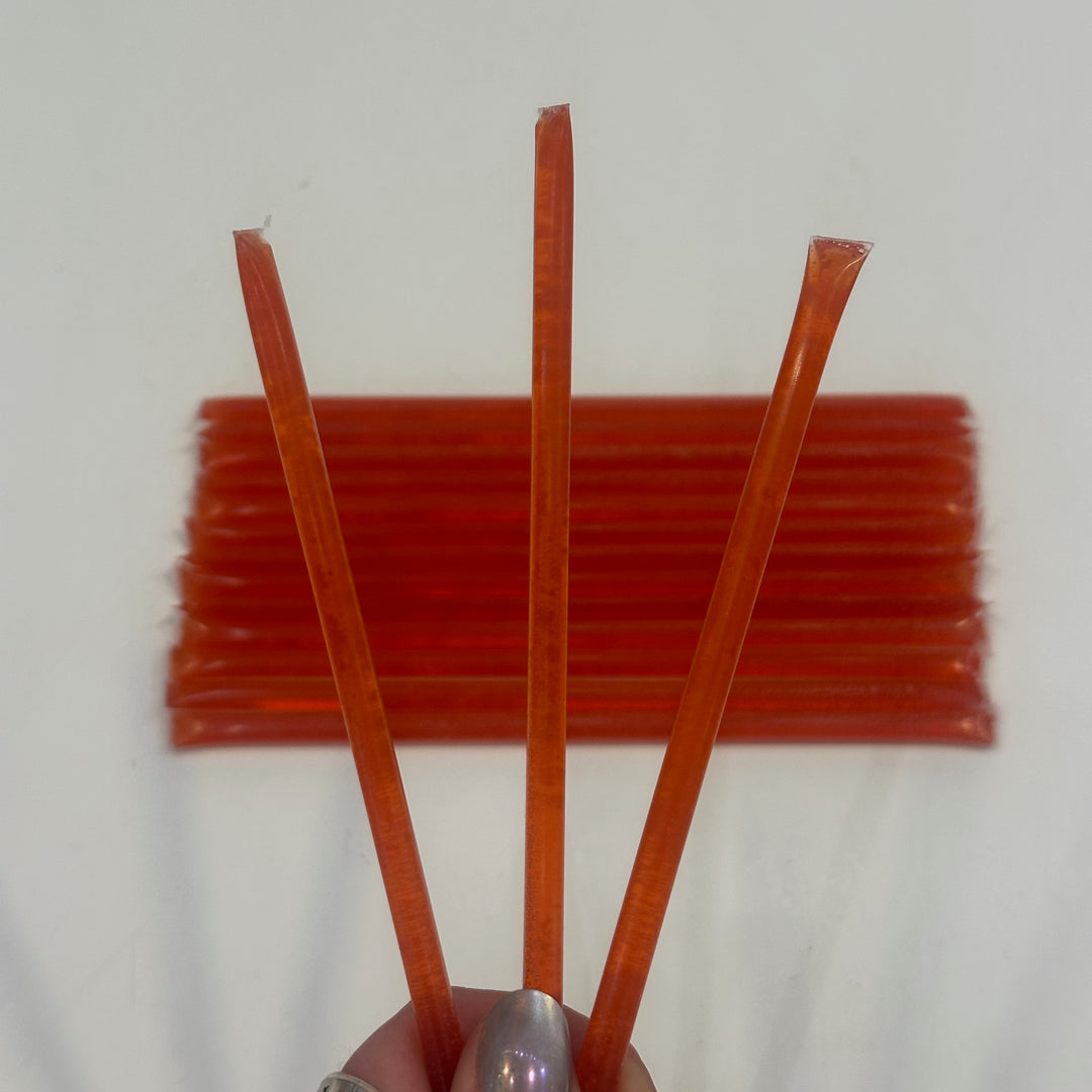 Three sour strawberry flavored Honey sticks made in Montana