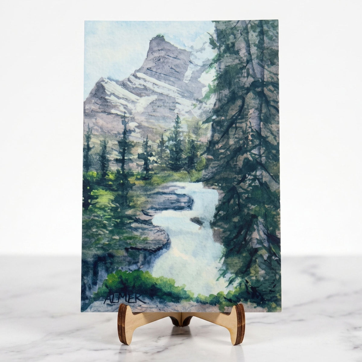 Capture Glacier National Park with the St. Mary Falls Postcard by Stark Mountain Studio, featuring Bobbe Almer watercolor art. Ideal gift or keepsake.