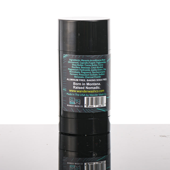 Back (ingredients list) of a 3 oz tube of Natural Deodorant Blue Stick (bergamot, citrus, aromatic herbs) made in Montana by Wander Wash Co, against a white background