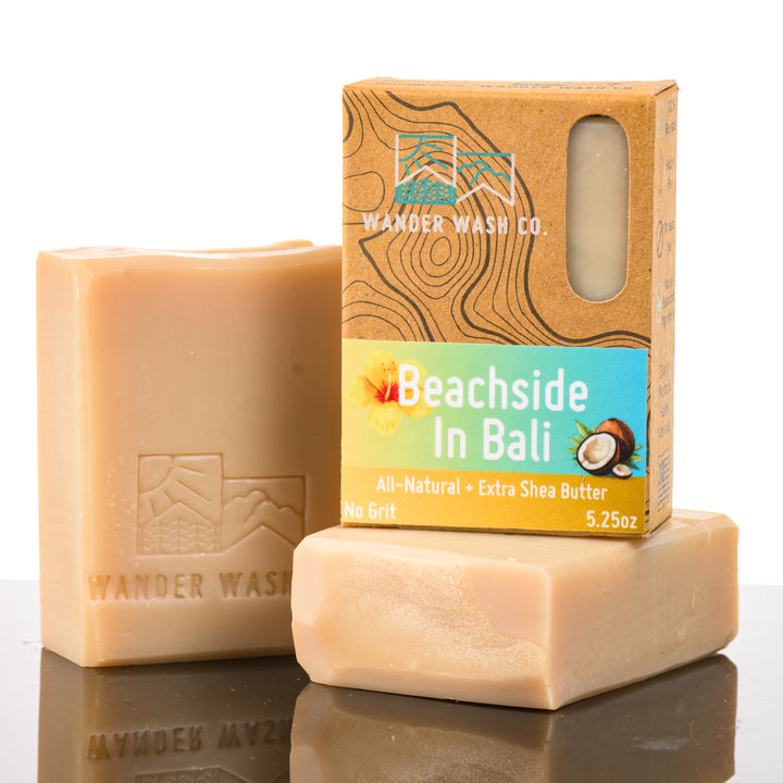 Display of three 5.25 oz bars of Beachside In Bali Bar Soap, Natural Cold Process Soap (with shea butter)—one in the box and two out of the box--made in Montana by Wander Wash Co, against a white background