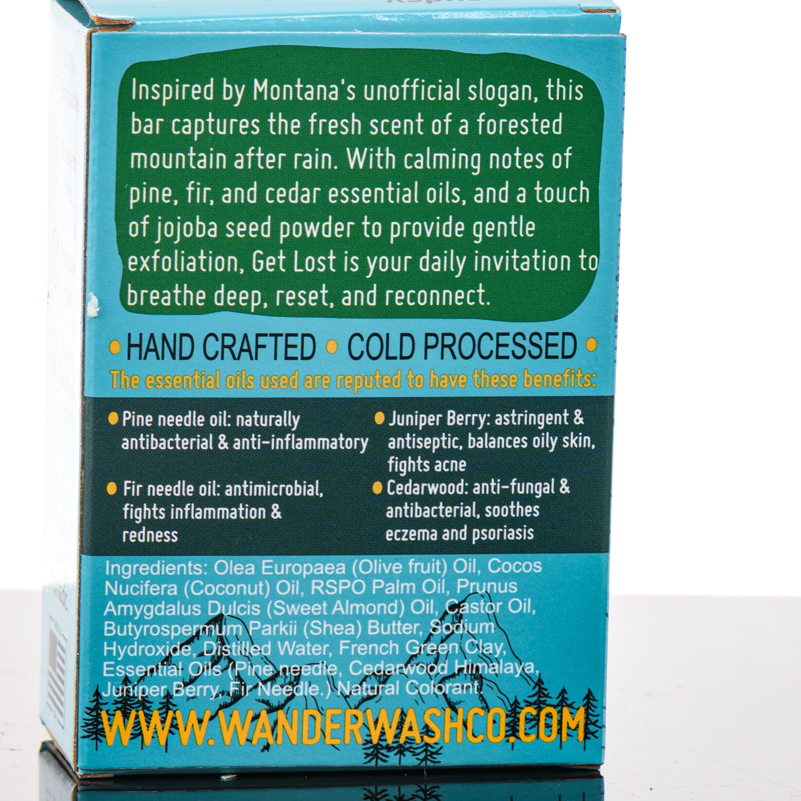Display of three 5.25 oz bars of Get Lost (In Nature) Bar Soap, Natural Cold Process Soap (pine, fir, cedar, juniper berry)—one in the box and two out of the box--made in Montana by Wander Wash Co, focused on back (ingredients list) against a white background