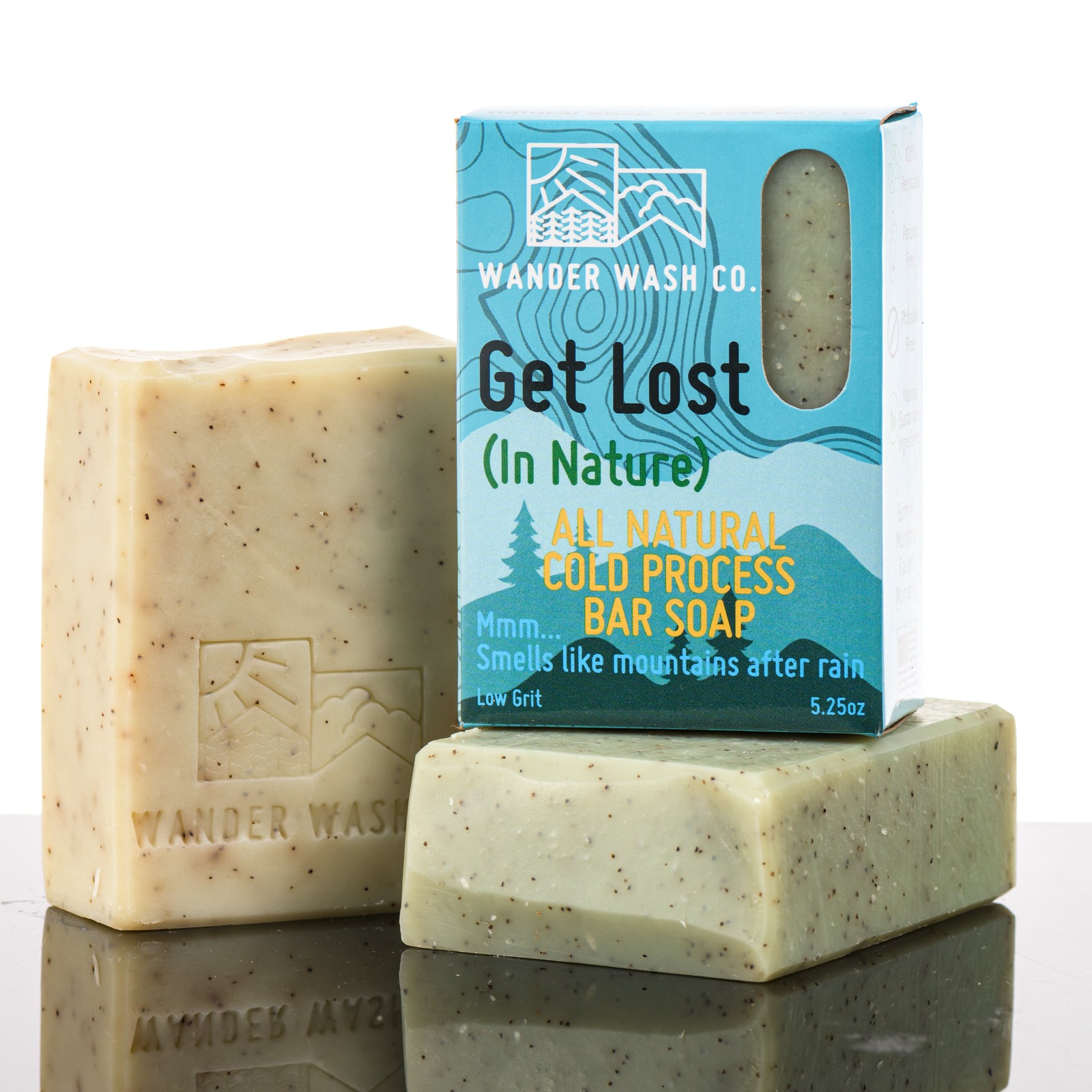 Display of three 5.25 oz bars of Get Lost (In Nature) Bar Soap, Natural Cold Process Soap (pine, fir, cedar, juniper berry)—one in the box and two out of the box--made in Montana by Wander Wash Co, against a white background