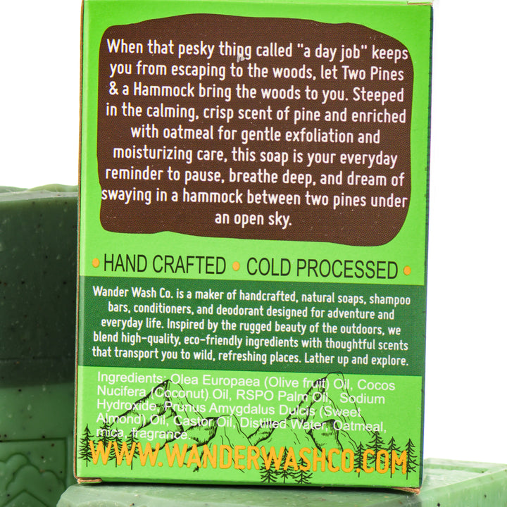 Display of three 5.25 oz bars of Two Pines &amp; A Hammock Bar Soap, Natural Cold Process Soap (pine, oatmeal)—one in the box and two out of the box--made in Montana by Wander Wash Co, focused on back (ingredients list) against a white background