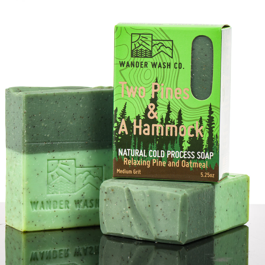 Display of three 5.25 oz bars of Two Pines &amp; A Hammock Bar Soap, Natural Cold Process Soap (pine, oatmeal)—one in the box and two out of the box--made in Montana by Wander Wash Co, against a white background