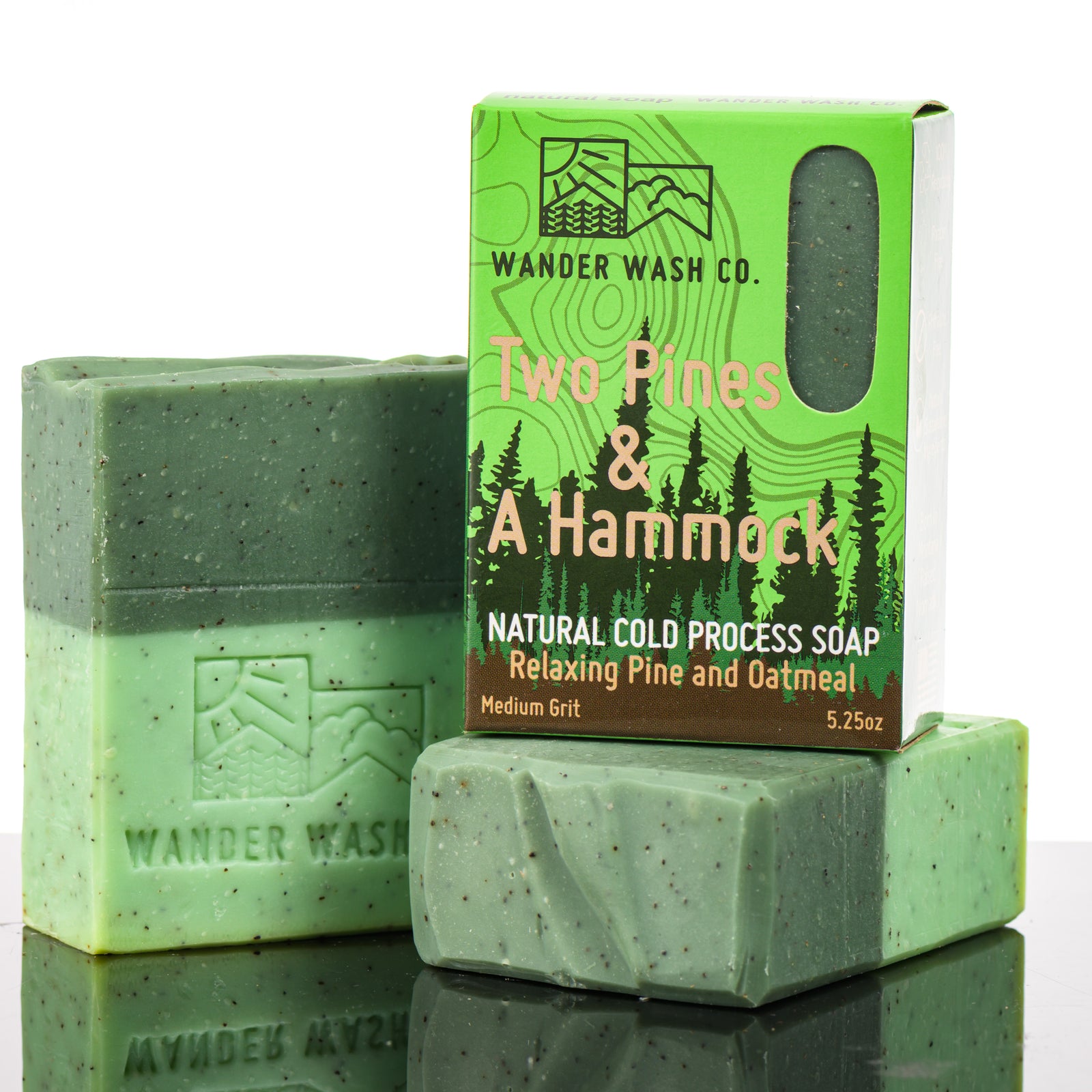 Display of three 5.25 oz bars of Two Pines & A Hammock Bar Soap, Natural Cold Process Soap (pine, oatmeal)—one in the box and two out of the box--made in Montana by Wander Wash Co, against a white background