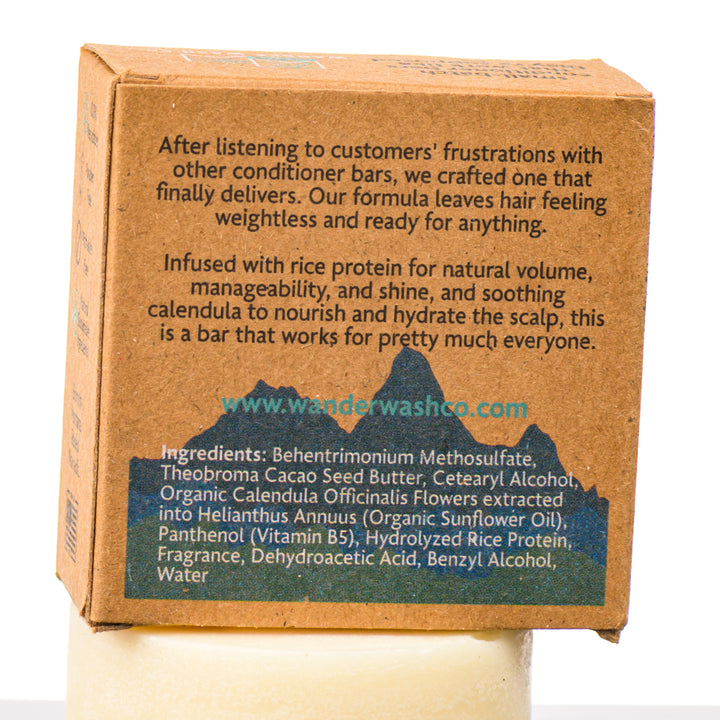 Back of a 1.7 oz box of This Doesn’t Float Conditioner Bar (bergamot, fresh water)—made in Montana by Wander Wash Co, focused on back (ingredients list) against a white background