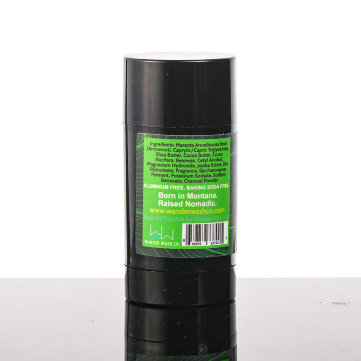 Back (ingredients list) of a 3 oz tube of Natural Deodorant Green Stick (pine, cedar wood, clove, peppercorn) made in Montana by Wander Wash Co, against a white background