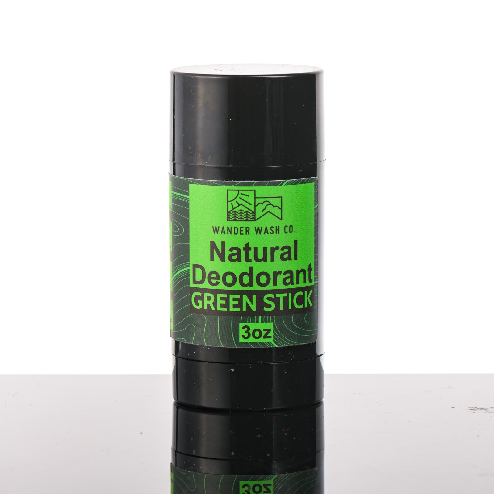 Front of a 3 oz tube of Natural Deodorant Green Stick (pine, cedar wood, clove, peppercorn) made in Montana by Wander Wash Co, against a white background