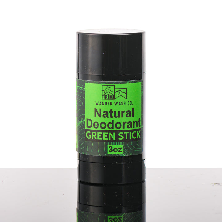 Front of a 3 oz tube of Natural Deodorant Green Stick (pine, cedar wood, clove, peppercorn) made in Montana by Wander Wash Co, against a white background
