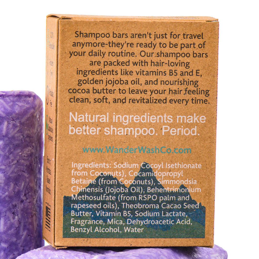 Display of three 4.5 oz bars of Beach Bum Blond Purple Shampoo Bar (for blonde and gray hair)—one in the box and two out of the box--made in Montana by Wander Wash Co, focused on back (ingredients list) against a white background