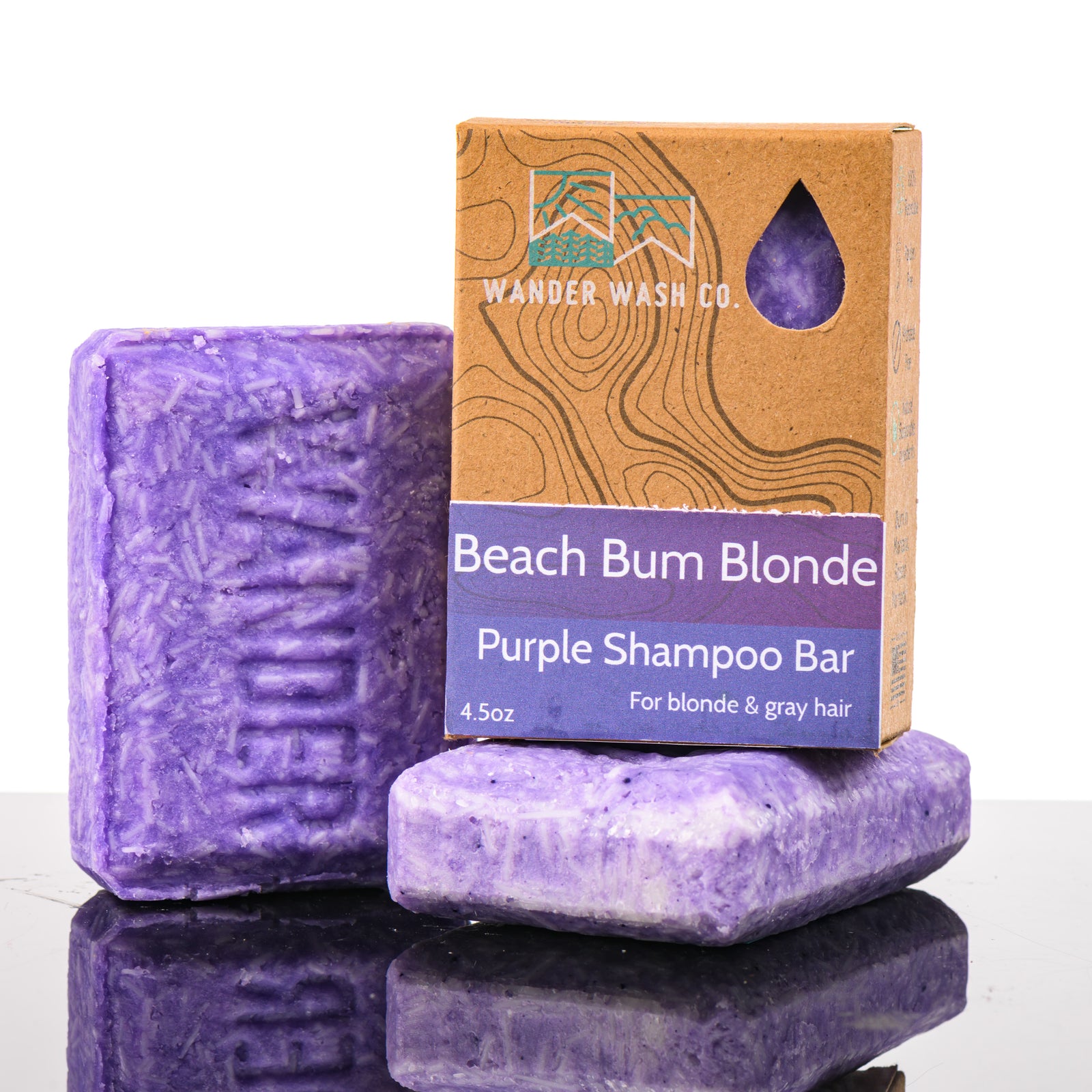 Display of three 4.5 oz bars of Beach Bum Blond Purple Shampoo Bar (for blonde and gray hair)—one in the box and two out of the box--made in Montana by Wander Wash Co, against a white background