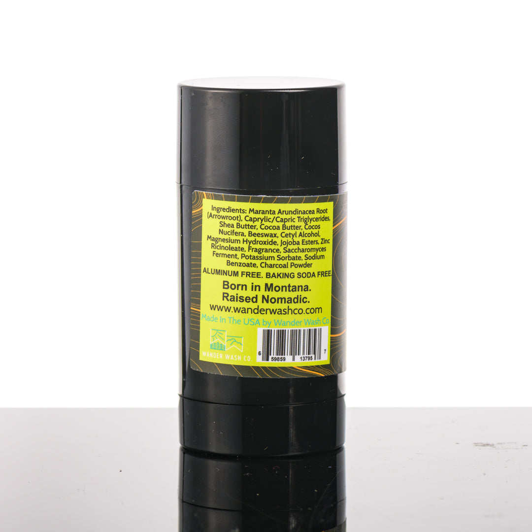 Back (ingredients list) of a 3 oz tube of Natural Deodorant Yellow Stick (citrus, wood, moon cactus, and musk) made in Montana by Wander Wash Co, against a white background