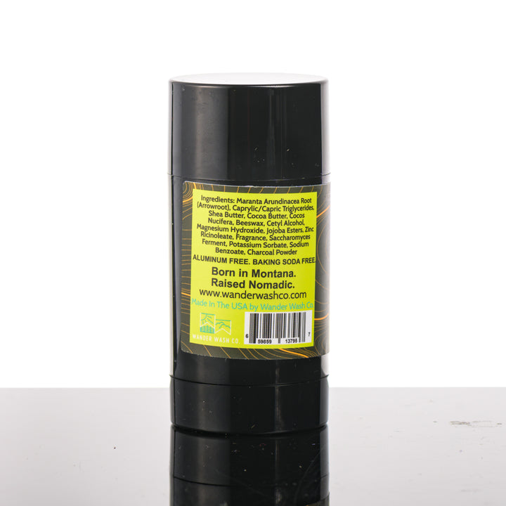 Back (ingredients list) of a 3 oz tube of Natural Deodorant Yellow Stick (citrus, wood, moon cactus, and musk) made in Montana by Wander Wash Co, against a white background