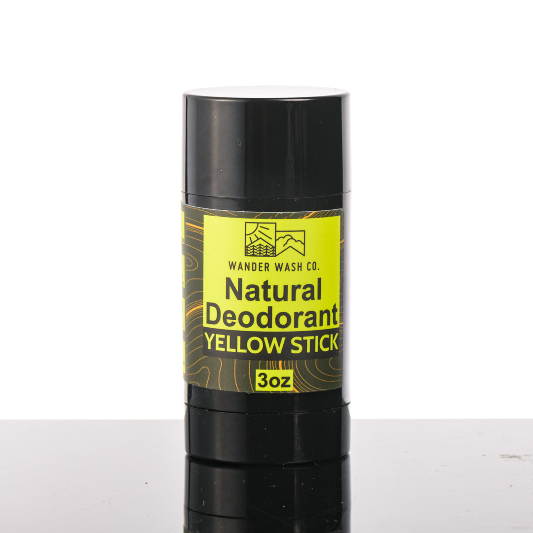 Front of a 3 oz tube of Natural Deodorant Yellow Stick (citrus, wood, moon cactus, and musk) made in Montana by Wander Wash Co, against a white background