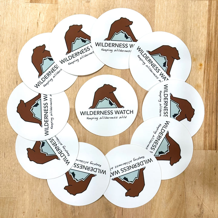 Circular array of Wilderness Watch 3" Vinyl Stickers- full-color water-resistant stickers featuring the Wilderness Watch logo; a portion of sales are donated to the Wilderness Watch fundraiser