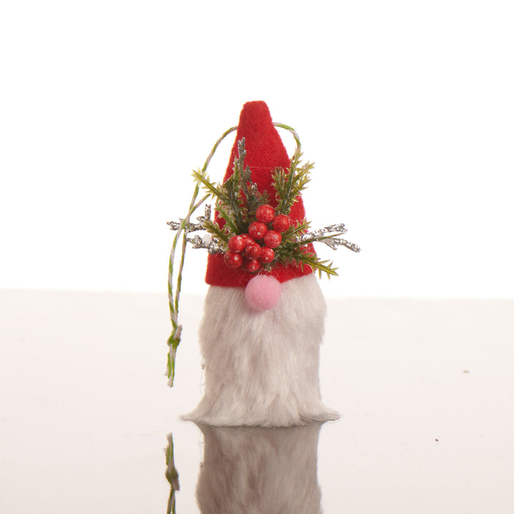 A gnome ornament, it is a white beard and nose and a red hat with berries.