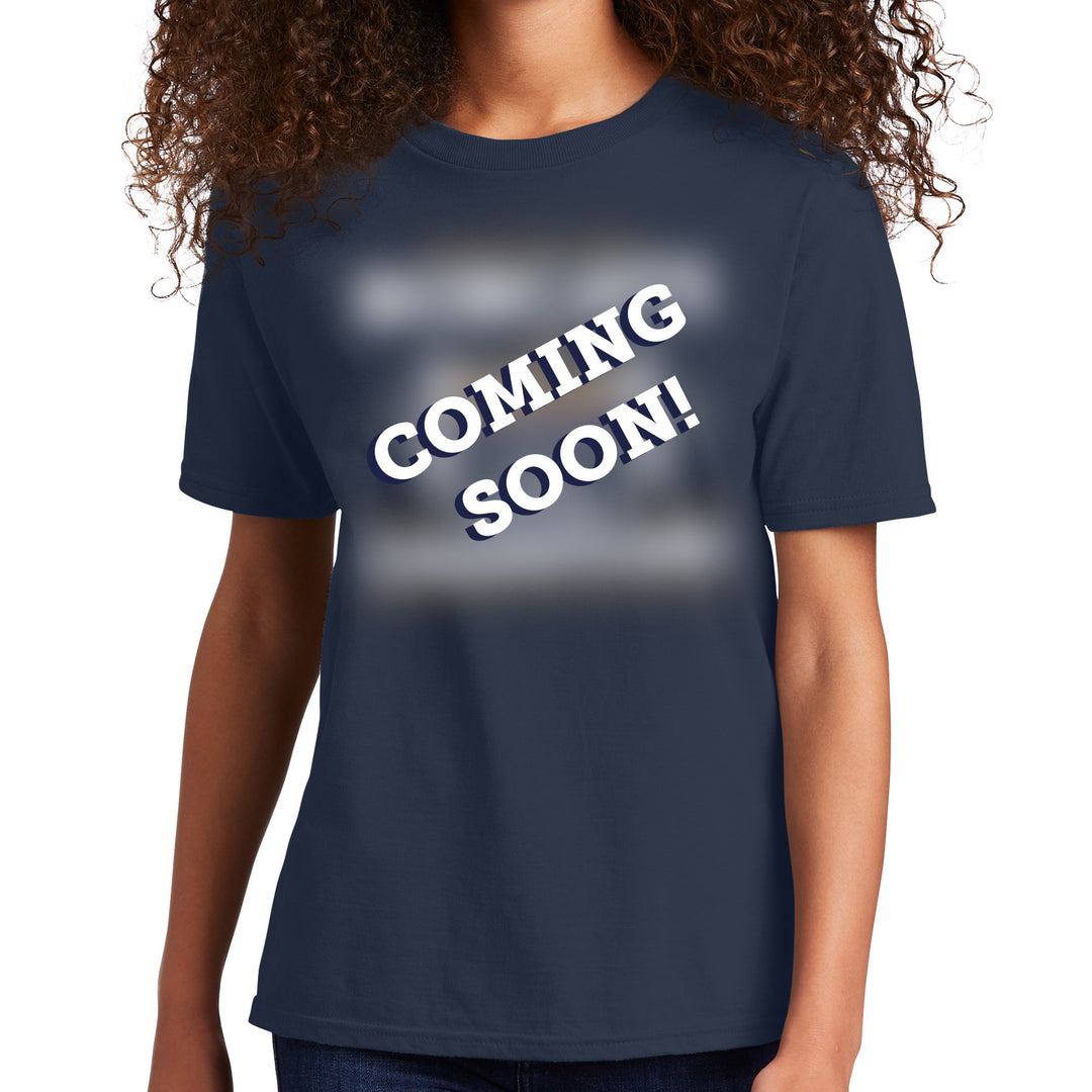a youth wearing a navy blue t-shirt with 'COMING SOON!' text on a white background in place of the MSU Bobcats championship tshirt