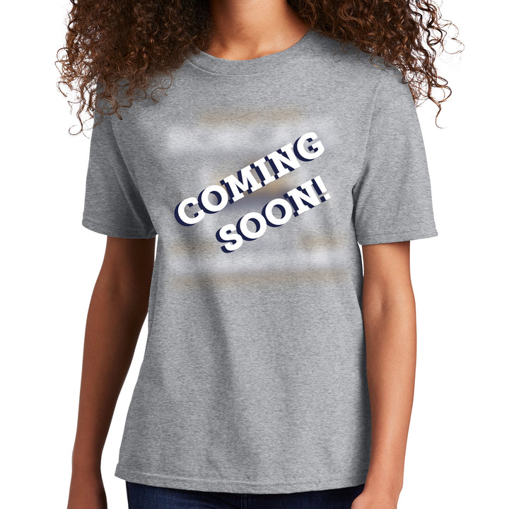 a youth wearing a gray t-shirt with 'COMING SOON!' text on a white background in place of the MSU Bobcats championship tshirt
